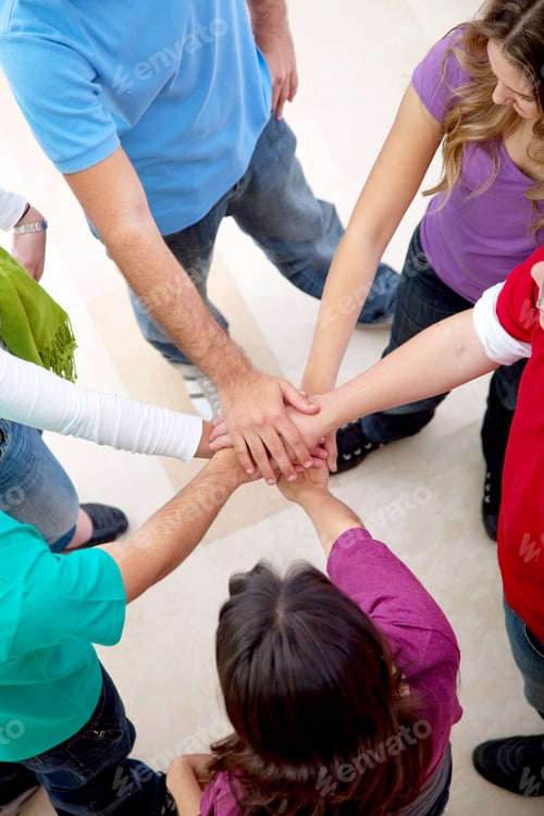 Preview: Happy Group Of Friends With Their Hands Together In The Middle