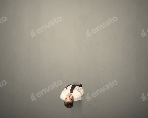 Preview: Young Businessman Contemplating A Decision Standing On A Grey Surface