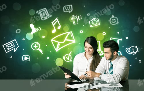 Preview: Business Couple Sitting At The Black Table With Social Media Symbols On The Background