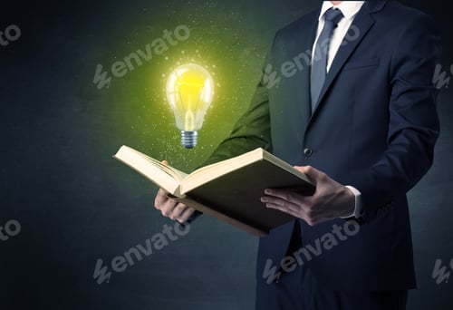 Preview: Businessman Holding Book With Bulb.