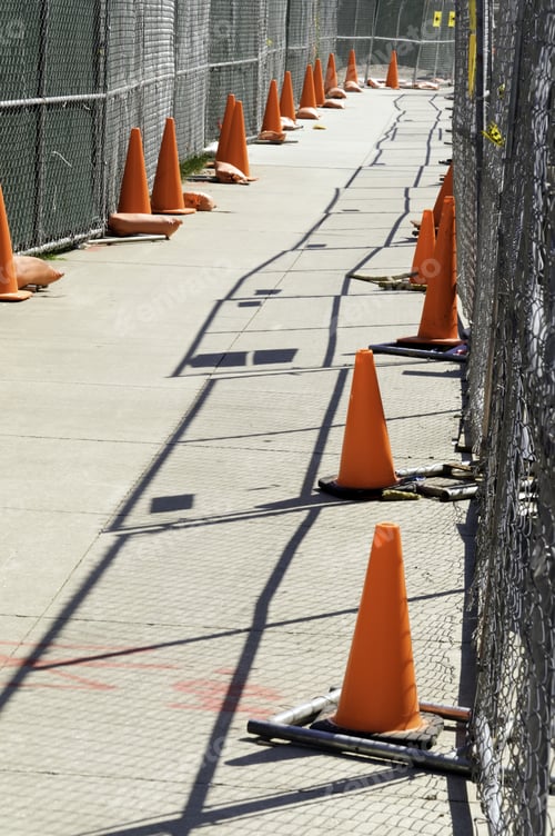 Preview: Fenced-In Pedestrian Walkway With Safety Cones In Construction Zone