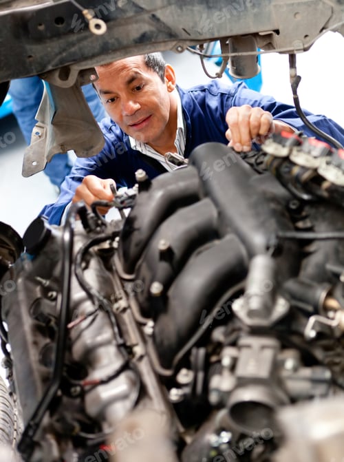 Preview: Male Mechanic At A Garage Fixing A Cars Engine