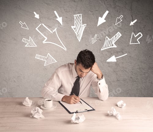 Preview: A Young Businessman Sitting At An Office Desk And Working On Paperwork With Drawn Arrows Pointing