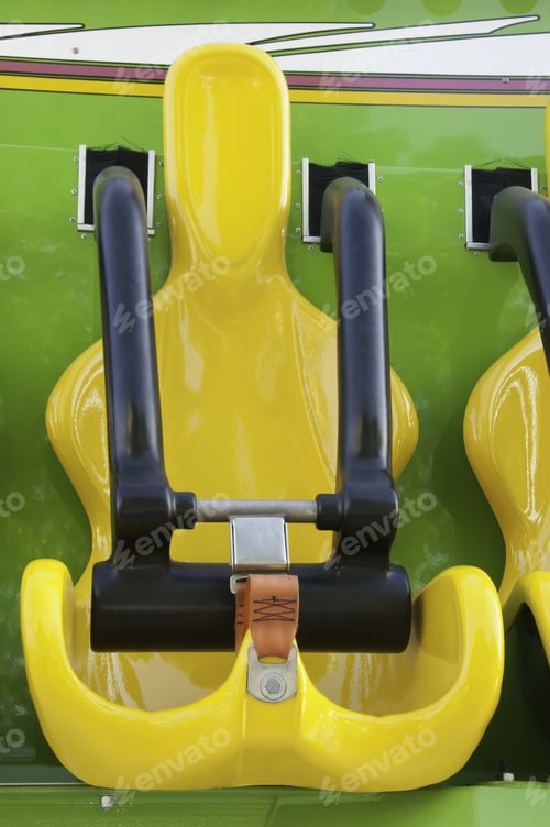 Preview: Yellow Seat With Black Safety Bar On Carnival Ride