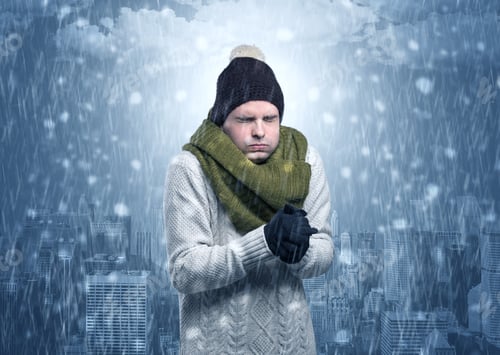 Preview: Young Man Freezing In Warm Clothing With City Concept