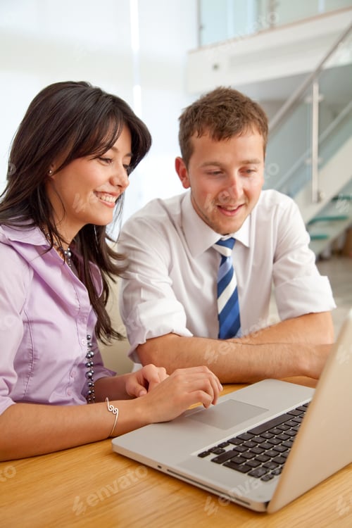 Preview: Business Couple Working On A Laptop Computer At An Office