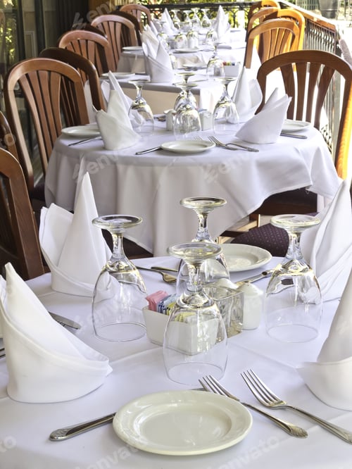 Preview: Table Settings On White Linen At Outdoor Restaurant