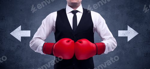 Preview: A Confident Businessman Standing With Red Boxing Gloves On His Hand In Front Of Arrows Pointing In