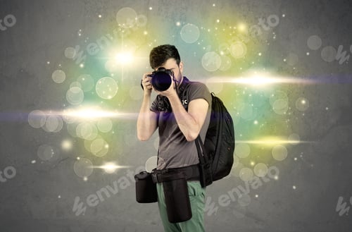 Preview: A Young Amateur Photographer With Professional Camera Equipment Taking Picture In Front Of Grey