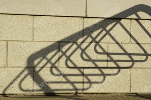 Preview: Shadow Of Bicycle Stand On Brick Wall Of Public Library