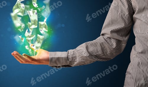 Preview: Businessman Holding Glowing Paper Moneys In His Hand