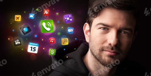 Preview: Portrait Of A Young Businessman With Colorful Applications Next To Him On A Dark Background