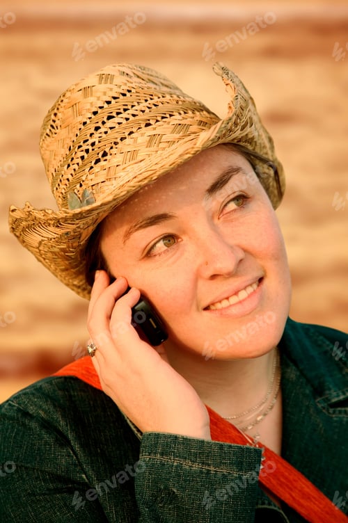 Preview: Girl Talking On A Cellphone At Sunset In Front Of The Sea