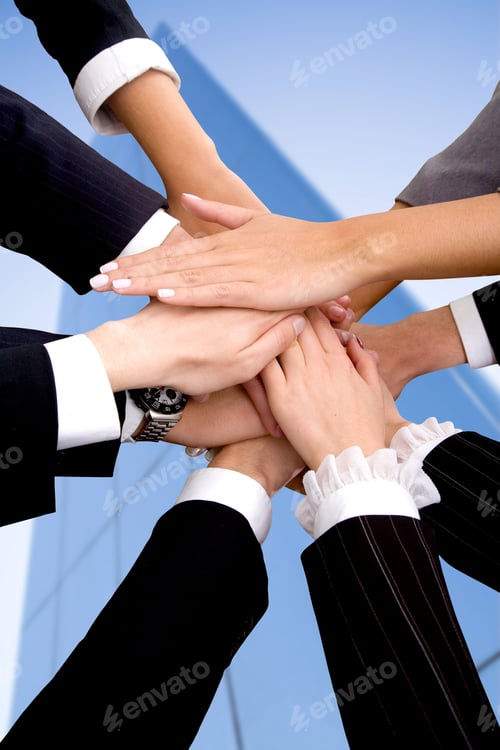 Preview: Business Team With Their Hands Together In The Middle