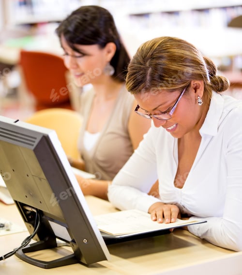 Preview: Female Student Reading A Book At The Library