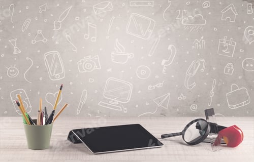 Preview: Close Up Of Business Office Desk With Laptop Tablet In Front Of Brown Wall Background Full Of Drawn