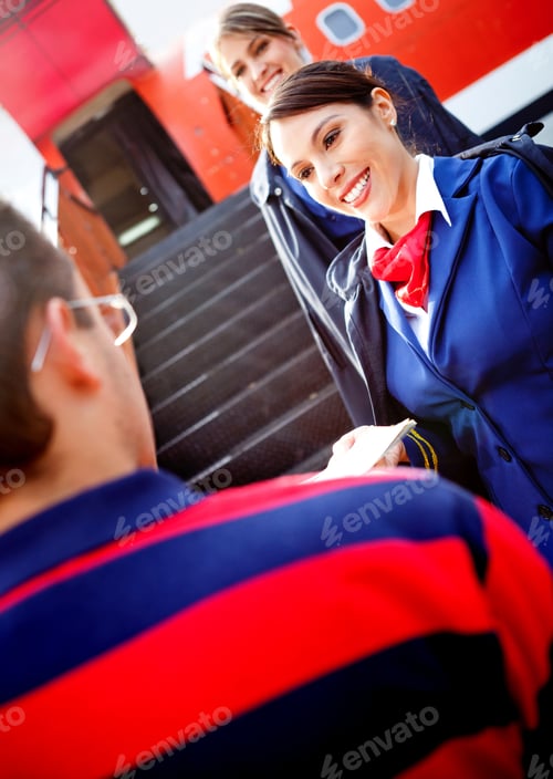 Preview: Friendly Air Hostesses Welcoming Passenger Into The Airplane
