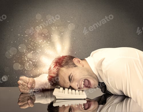 Preview: A Young Depressed Business Person Laying His Head On Computer Keyboard With Thoughts Exploding From
