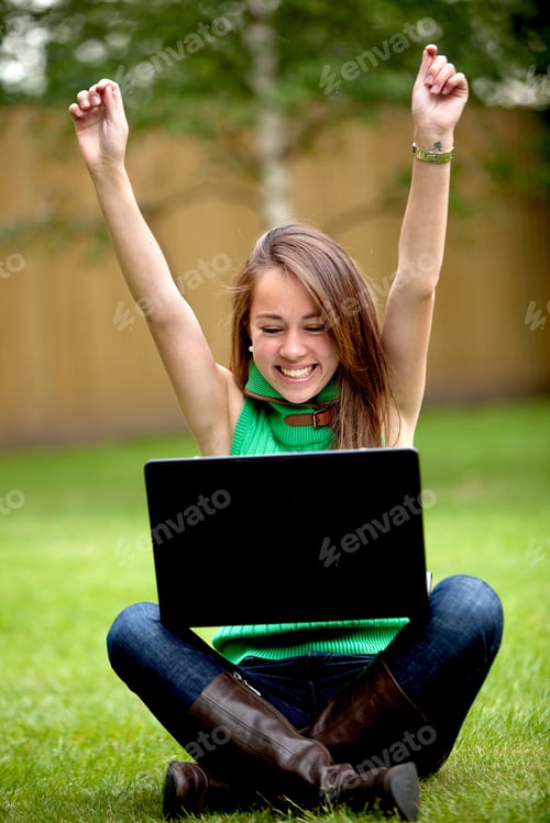 Preview: Casual Success Girl On A Laptop With Arms Up Outdoors