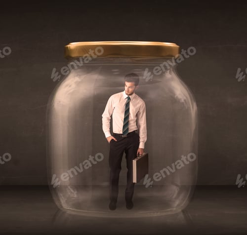 Preview: Businessman Shut Into A Glass Jar Concept On Background