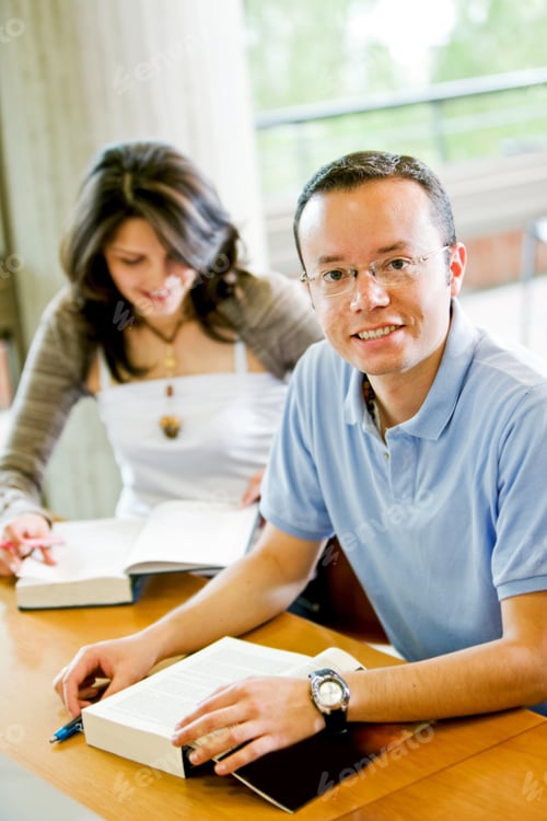 Preview: College Student In A Library Smiling And Facing The Camera