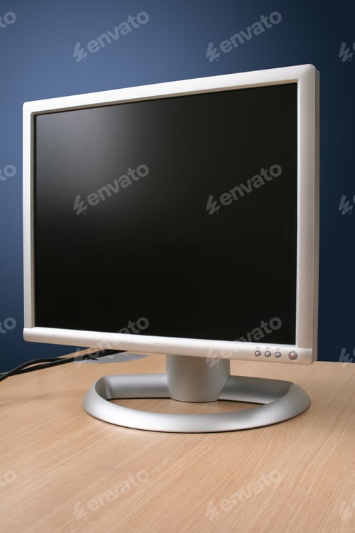 Preview: Flatscreen Monitor On A Wooden Desk Over Blue