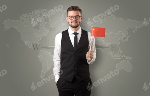 Preview: Cheerful Businessman Standing In Front Of A Map With Flag On His Hand