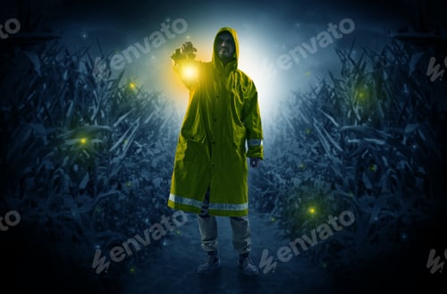 Preview: Man In Raincoat At Night Coming From Thicket And Looking Something With Glowing Lantern