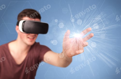 Preview: Young Impressed Man Wearing Virtual Reality Goggles With Blue Hexagons Around Him