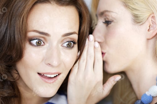Preview: Two Young Friends Whispering To Each Other Expressing Surprise