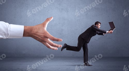 Preview: Young Miniature Businessman Running From A Big Hand With Blueish Grey Background