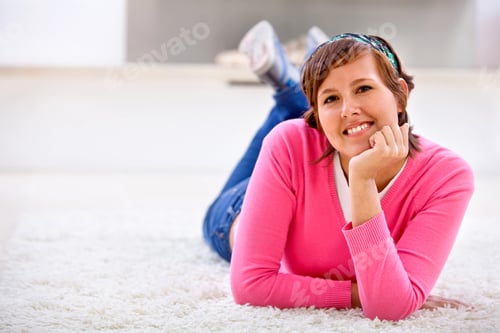Preview: Happy Casual Woman Lying On The Carpet