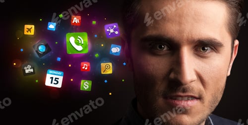 Preview: Portrait Of A Young Businessman With Colorful Applications Next To Him On A Dark Background