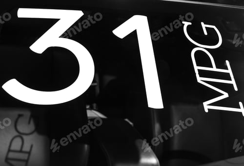 Preview: Sign Of Fuel Efficiency On Windshield Of New Car At Auto Show, In Black And White