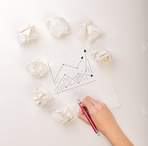 Preview: Female Hand Next To A Few Crumpled Paper Balls Drawing A Progress Chart