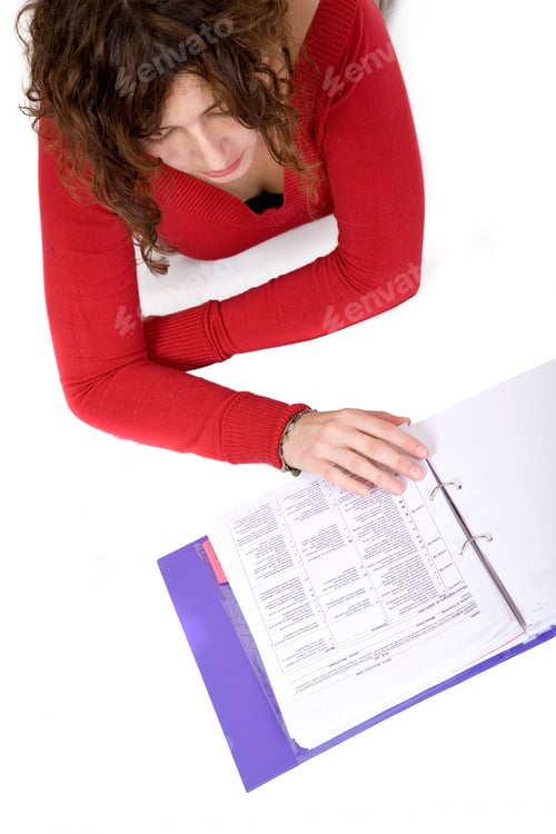 Preview: Adult Female Studying On The Floor Over A White Background