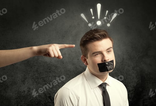 Preview: Caucasian Hand Pointing At Employee In Business Suit, With Drawn Exclamation Marks Above His Head