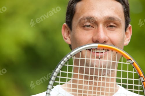 Preview: Man Outdoors Holding A Tennis Racket In Front Of His Face