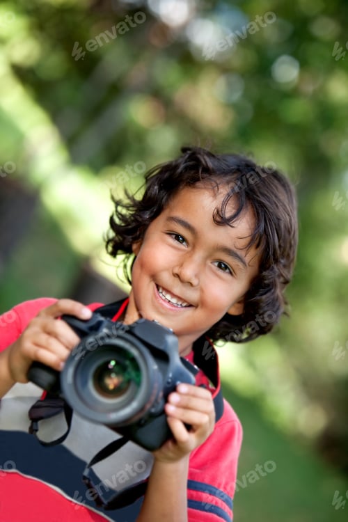 Preview: Boy Playing With A Camera Outdoors And Smiling