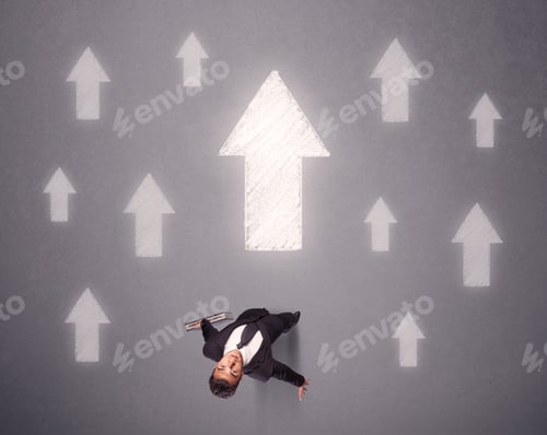 Preview: Young Contemplating Businessman Stands In Front Of White Arrows