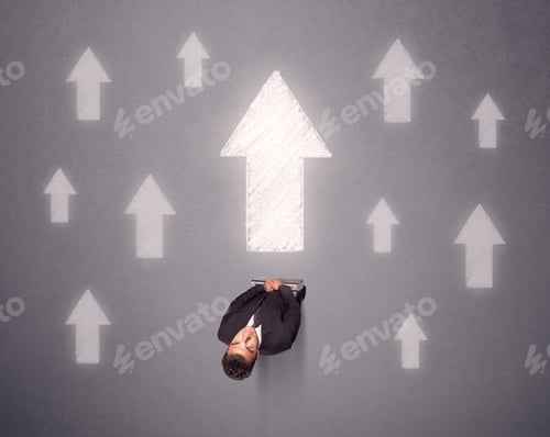 Preview: Young Contemplating Businessman Stands In Front Of White Arrows