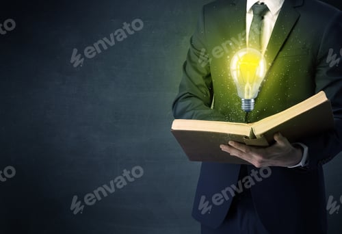 Preview: Businessman Holding Book With Bulb.