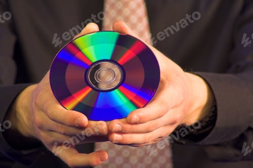 Preview: Business Hands Holding A Cd