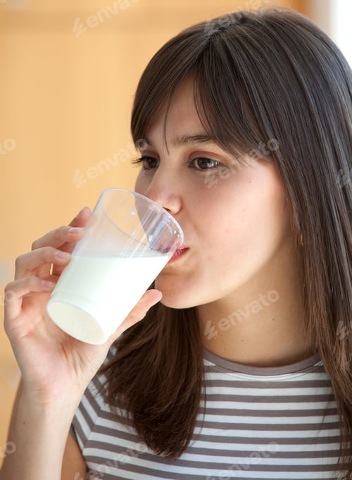 Preview: Portrait Of A Beautiful Brunette Girl Drinking Milk