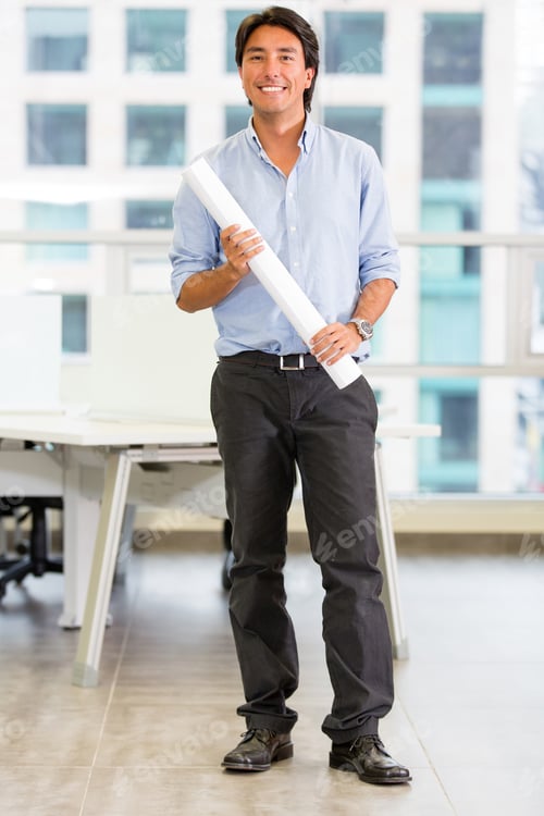Preview: Architect At The Office Holding A Blueprint And Smiling