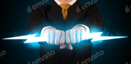 Preview: Business Man Holding Glowing Lightning Bolt In His Hands Concept