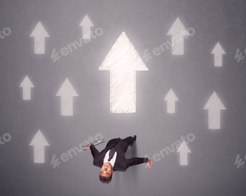 Preview: Young Contemplating Businessman Stands In Front Of White Arrows