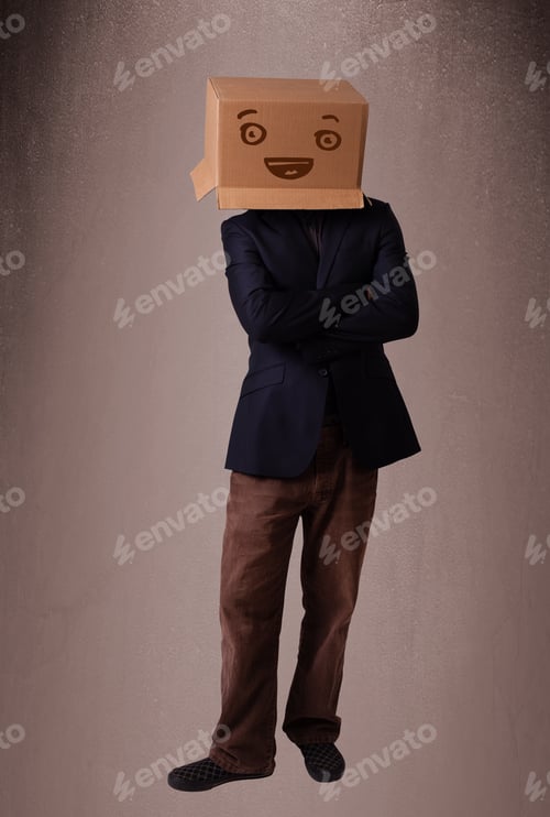 Preview: Young Man Standing And Gesturing With A Cardboard Box On His Head With Smiley Face