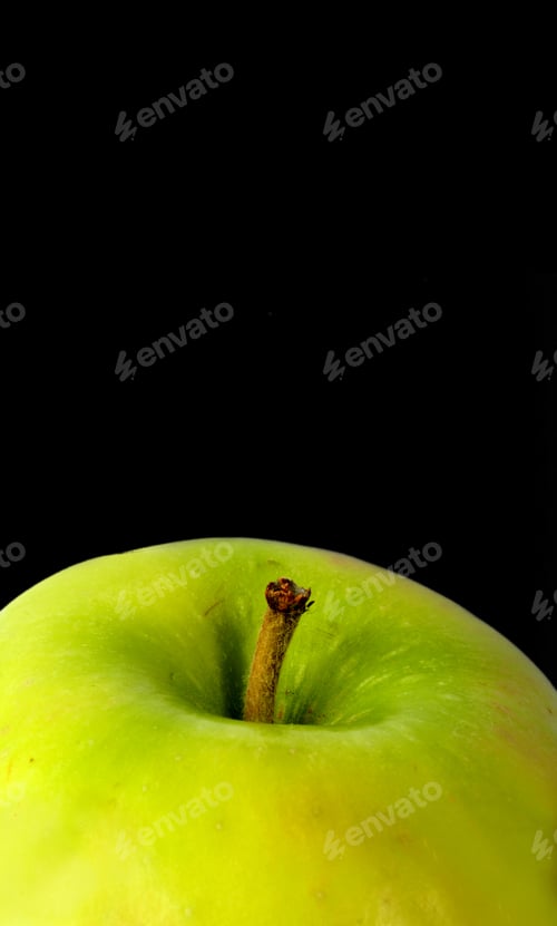 Preview: Green Apple Close Up Over A Black Background