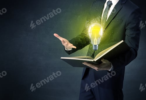 Preview: Businessman Holding Book With Bulb.